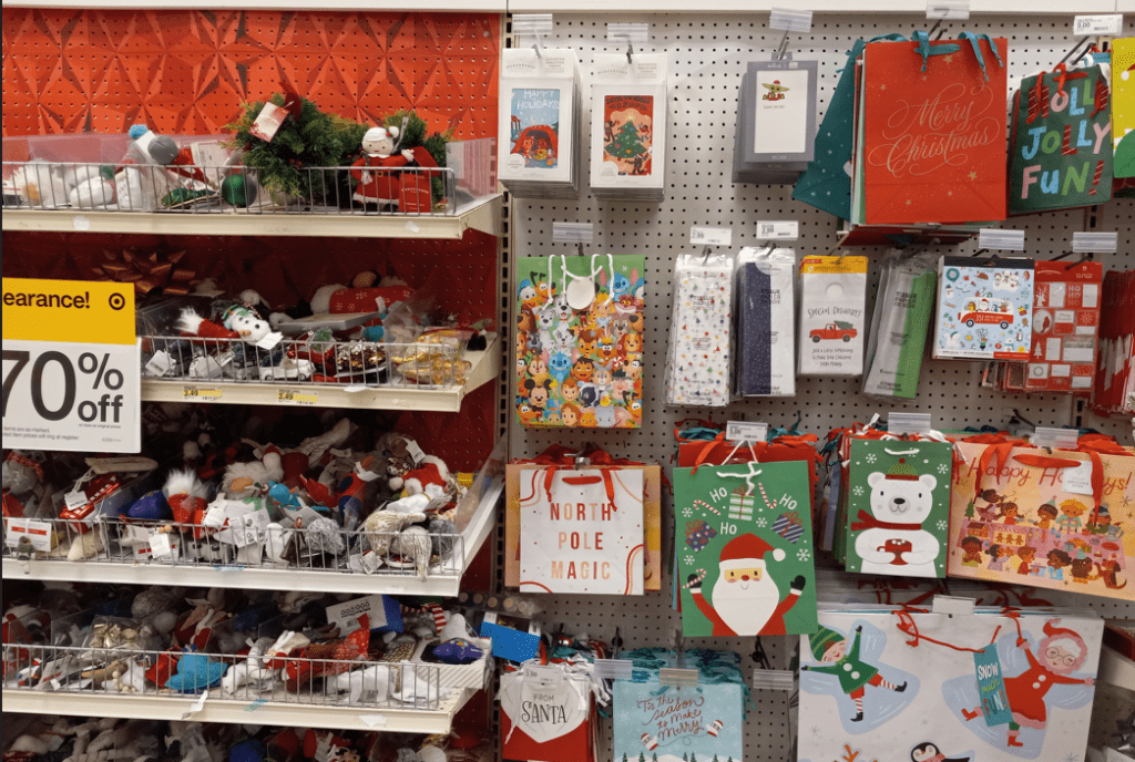 Target Christmas Clearance gift bags hanging on a pegboard.