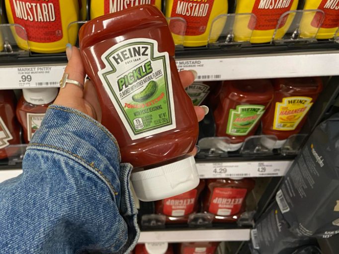 Heinz Pickle Ketchup being held up in front of the ketchup section at Target